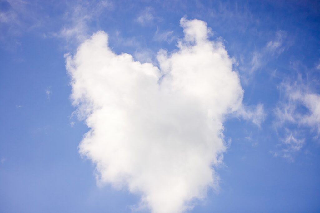 bright blue sky with heart shaped cloud
